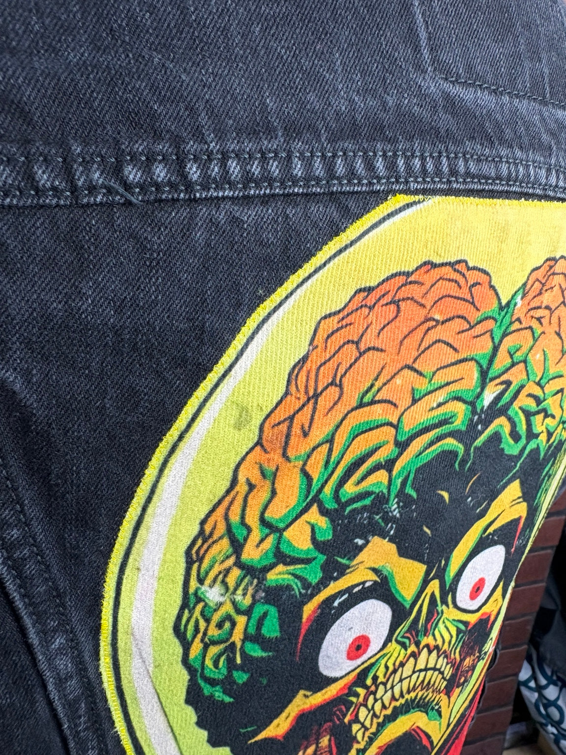 Close-up of stitching on the Mars Attacks! back graphic